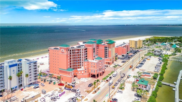 birds eye view of property with a beach view and a water view