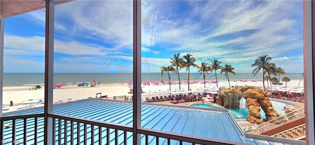 view of swimming pool featuring a beach view and a water view