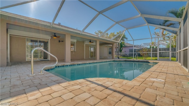 view of pool with ceiling fan, a lanai, and a patio area