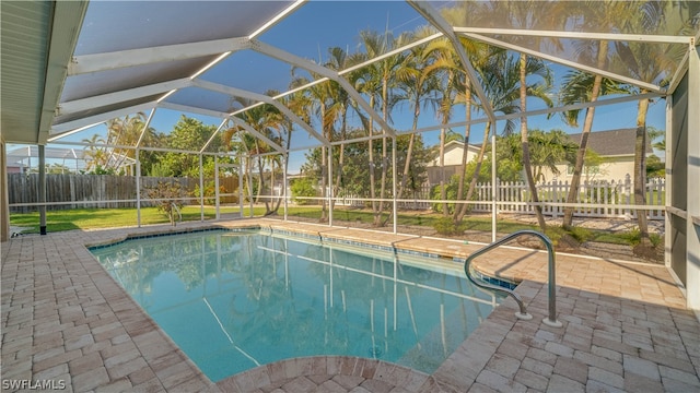 view of pool with a patio and glass enclosure