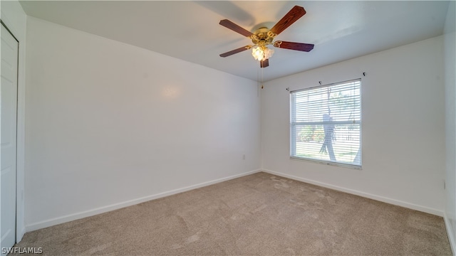 unfurnished room with carpet floors and ceiling fan