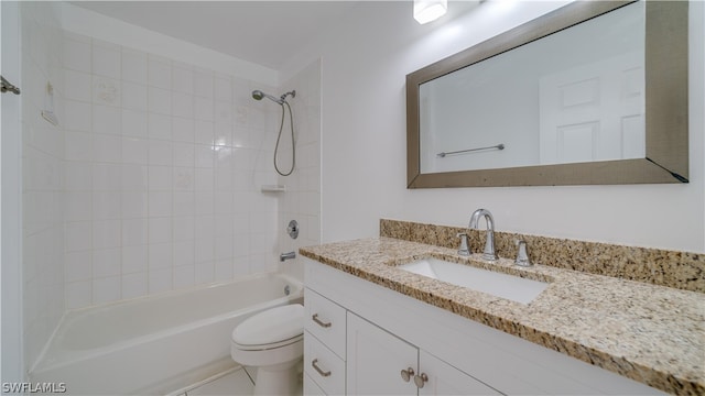 full bathroom featuring vanity with extensive cabinet space, toilet, and tiled shower / bath combo