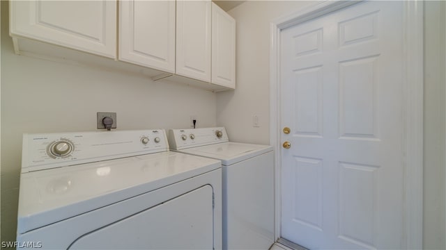 laundry room with washer and dryer, cabinets, and electric dryer hookup