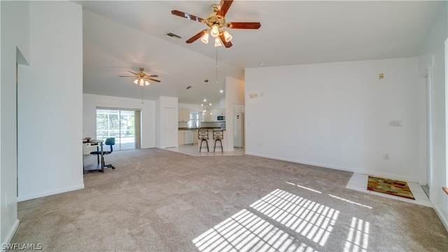 unfurnished living room with high vaulted ceiling, ceiling fan, and light colored carpet