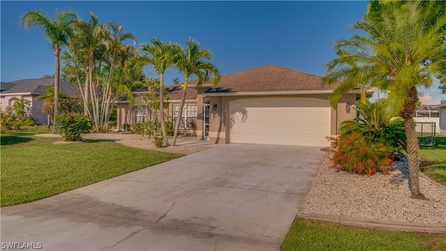 view of front of property with a front yard and a garage