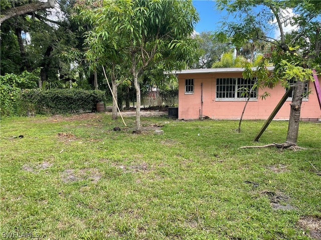 view of yard featuring central air condition unit