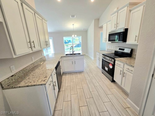 kitchen with sink, hanging light fixtures, white cabinetry, kitchen peninsula, and stainless steel appliances