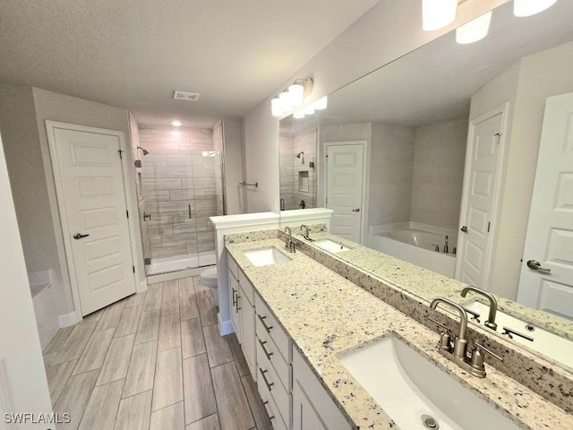 full bathroom with plus walk in shower, vanity, and toilet