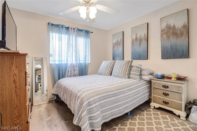 bedroom with ceiling fan and hardwood / wood-style flooring