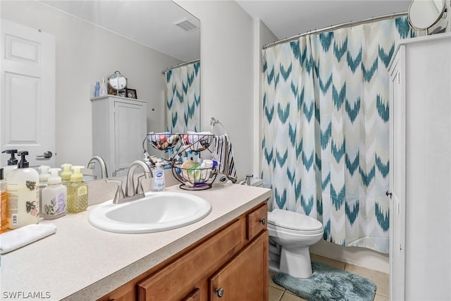 bathroom with toilet, a shower with curtain, vanity, and tile patterned floors