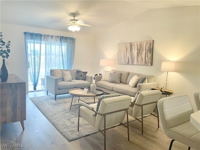 living room with vaulted ceiling, ceiling fan, and light hardwood / wood-style floors