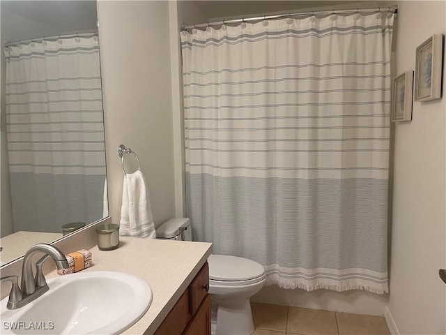 bathroom featuring vanity, curtained shower, tile patterned floors, and toilet