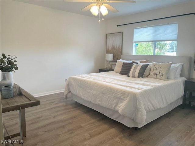 bedroom featuring dark wood-type flooring and ceiling fan