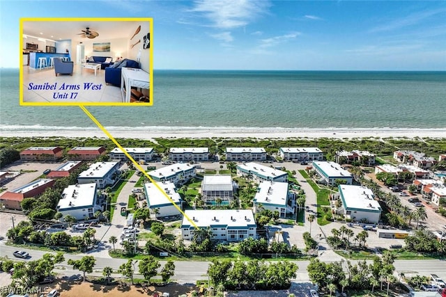 drone / aerial view with a water view and a view of the beach