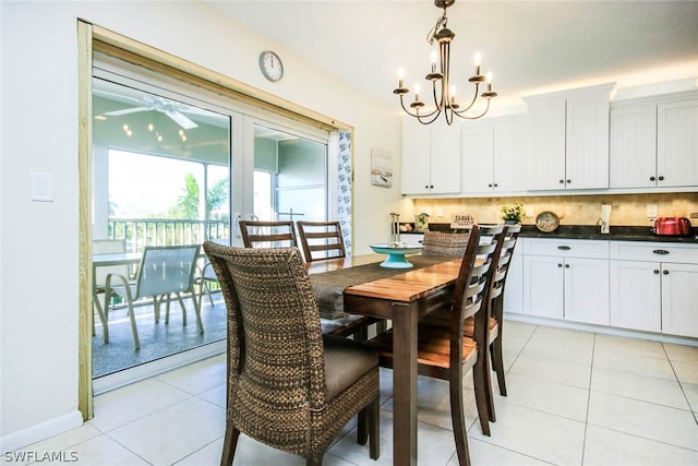 tiled dining room featuring an inviting chandelier