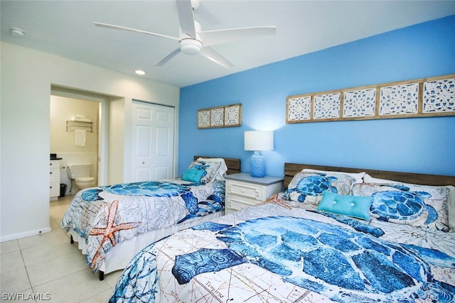 tiled bedroom with ensuite bath, ceiling fan, and a closet