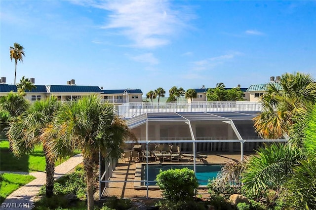 outdoor pool featuring a patio area and a lanai