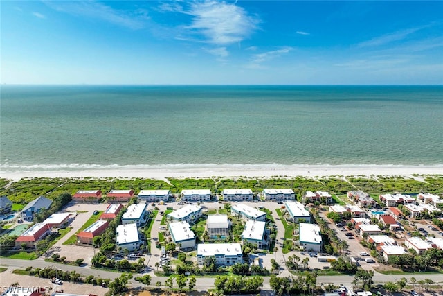 birds eye view of property featuring a beach view and a water view