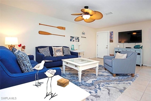 living room featuring ceiling fan, visible vents, and tile patterned floors