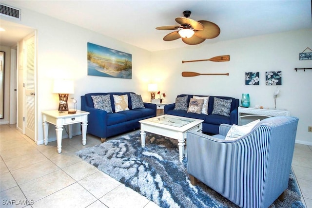 tiled living room featuring baseboards, visible vents, and a ceiling fan