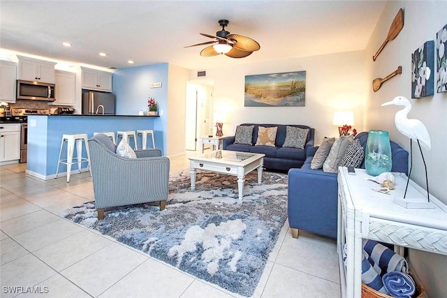 living area with light tile patterned floors, visible vents, a ceiling fan, and recessed lighting