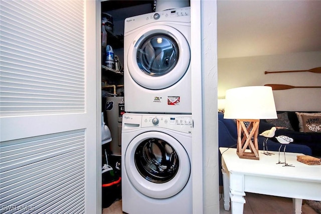 laundry area featuring stacked washer and clothes dryer and laundry area