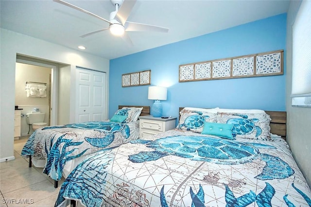 bedroom with a closet, light tile patterned flooring, ceiling fan, and ensuite bath