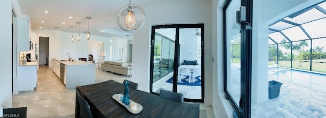 dining room featuring sink and a chandelier