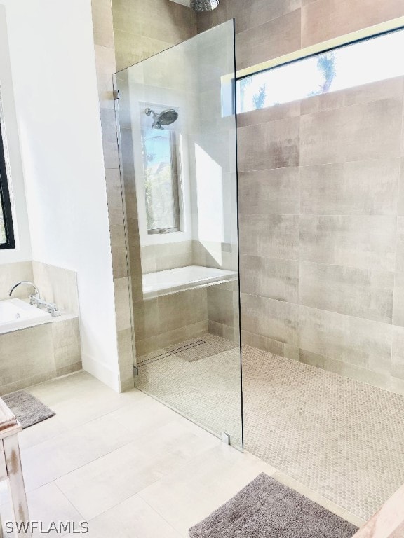 bathroom featuring tile patterned floors and independent shower and bath