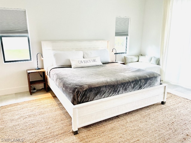 carpeted bedroom featuring multiple windows