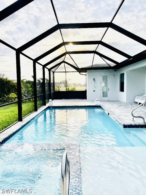 view of pool with a patio and a lanai