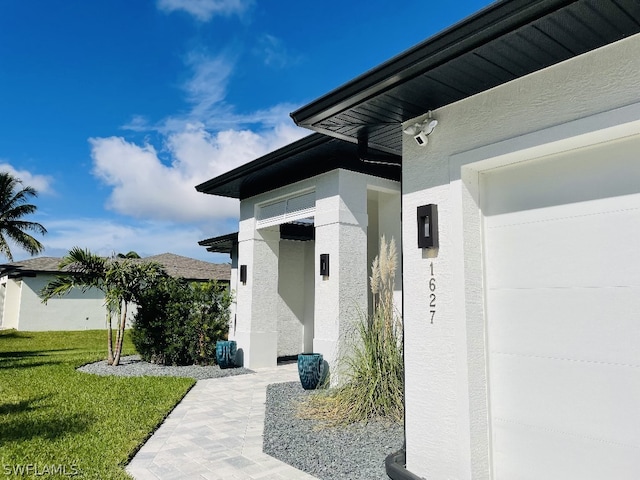 doorway to property featuring a lawn