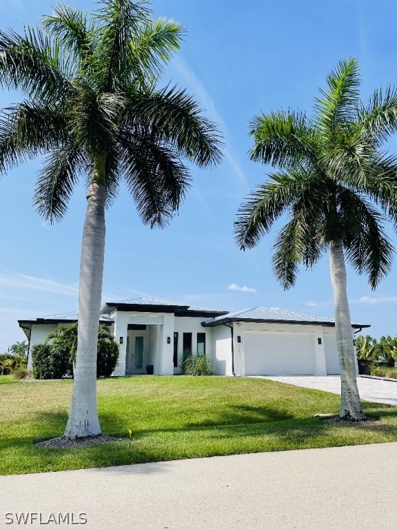 view of front of home with a garage and a front yard