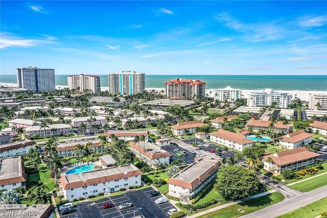 drone / aerial view featuring a view of city and a water view