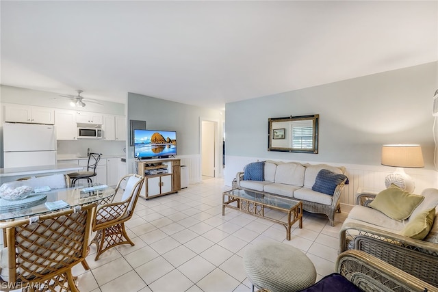 tiled living room with ceiling fan