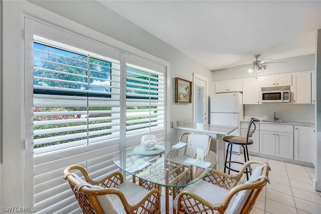 dining area with light tile patterned floors and ceiling fan