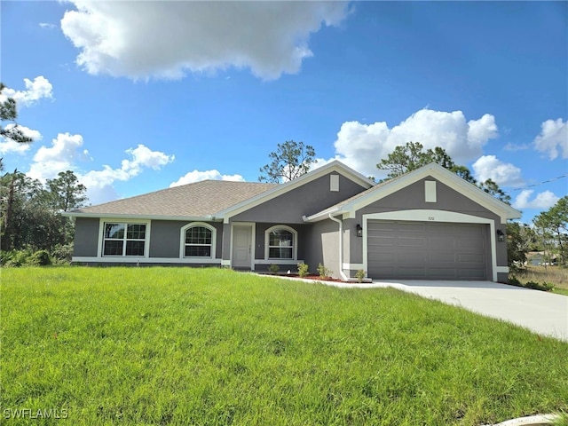 ranch-style home with stucco siding, a garage, concrete driveway, and a front yard