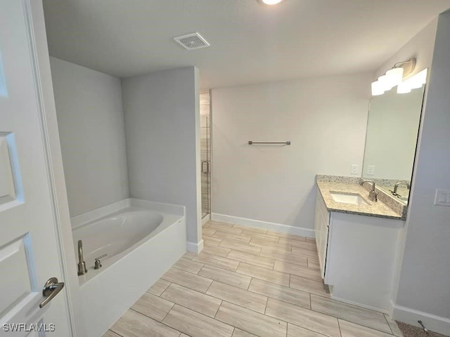 full bath with visible vents, a stall shower, vanity, a bath, and wood tiled floor