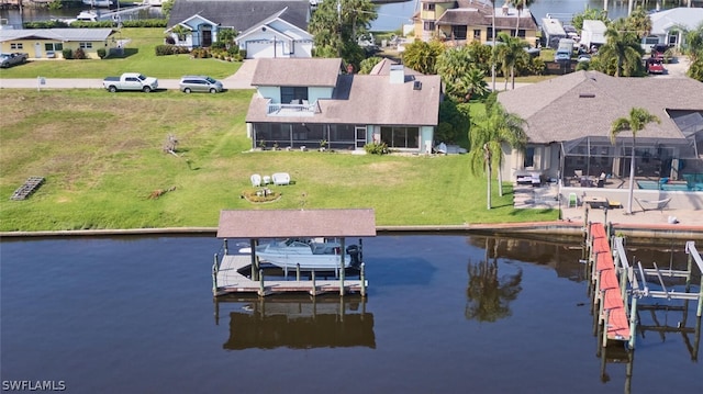 view of dock featuring a water view and a yard