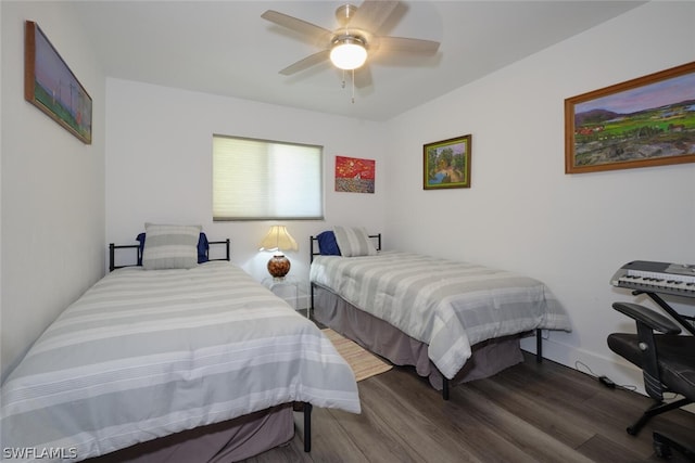 bedroom with dark hardwood / wood-style flooring and ceiling fan