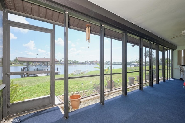 unfurnished sunroom with a water view