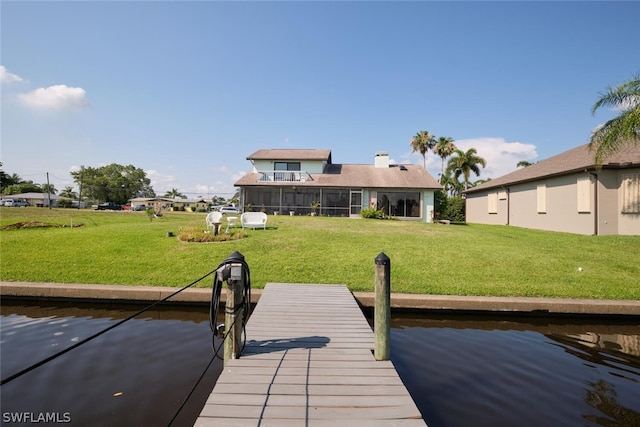 dock area featuring a water view and a yard