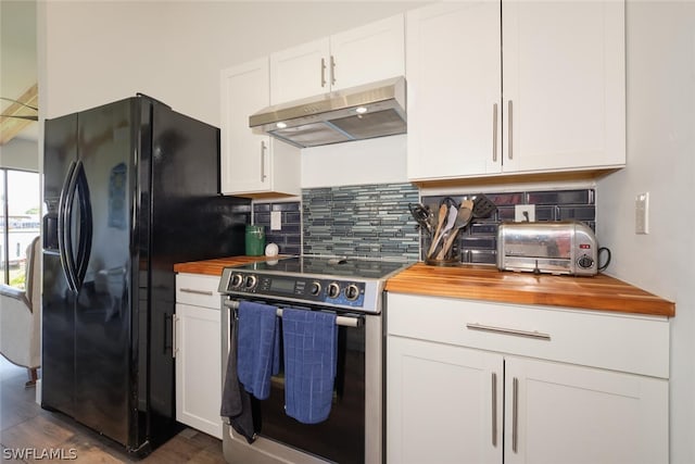 kitchen featuring tasteful backsplash, stainless steel range with electric stovetop, white cabinetry, dark wood-type flooring, and black fridge