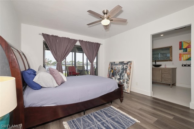 bedroom with dark hardwood / wood-style floors and ceiling fan