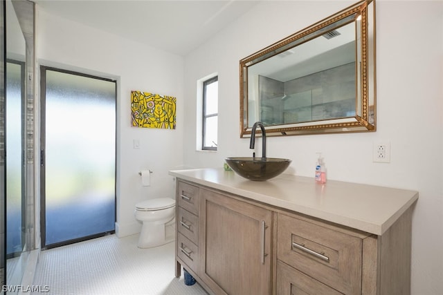 bathroom with vanity, tile patterned floors, and toilet