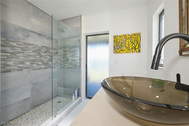 bathroom with sink, a shower with shower door, and tile patterned flooring