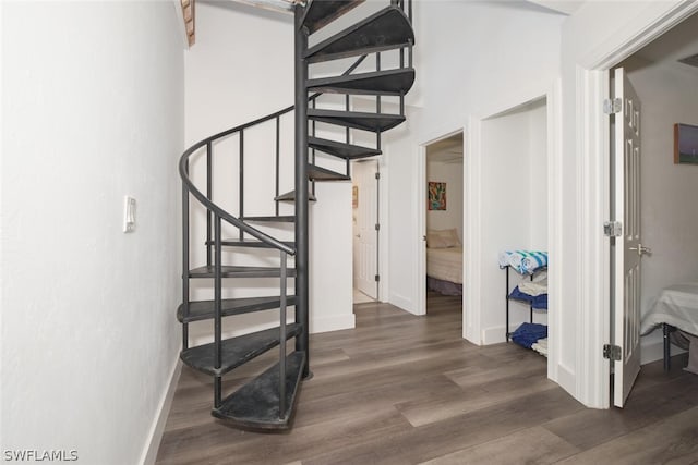 stairway featuring dark hardwood / wood-style floors