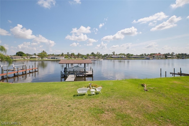 dock area with a water view and a lawn