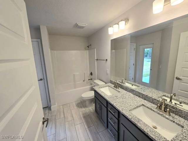 full bathroom with vanity, toilet, and washtub / shower combination