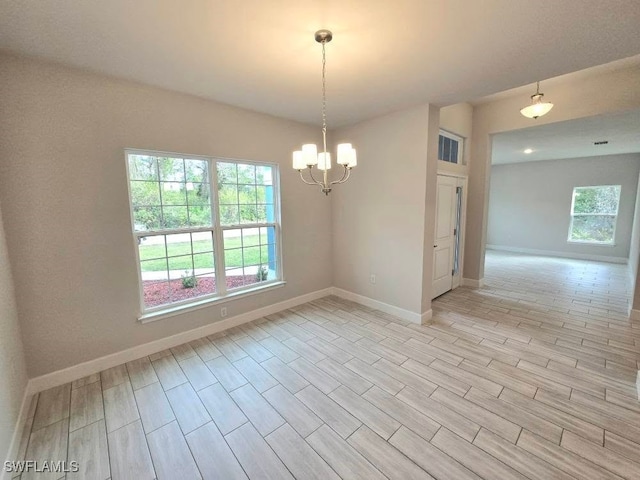 empty room featuring a chandelier